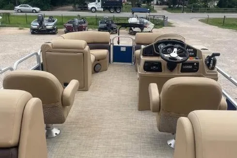 Slide: The Image of 2018 Lowe SS230 Walk-Thru pontoon boat interior with beige seating and steering console. - 6