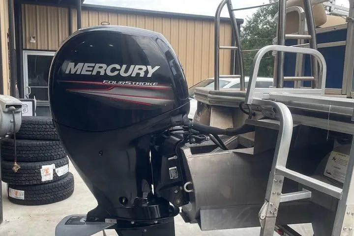 Slide: The Image of 2018 Lowe SS230 Walk-Thru with Mercury FourStroke outboard motor, parked near building. - 7