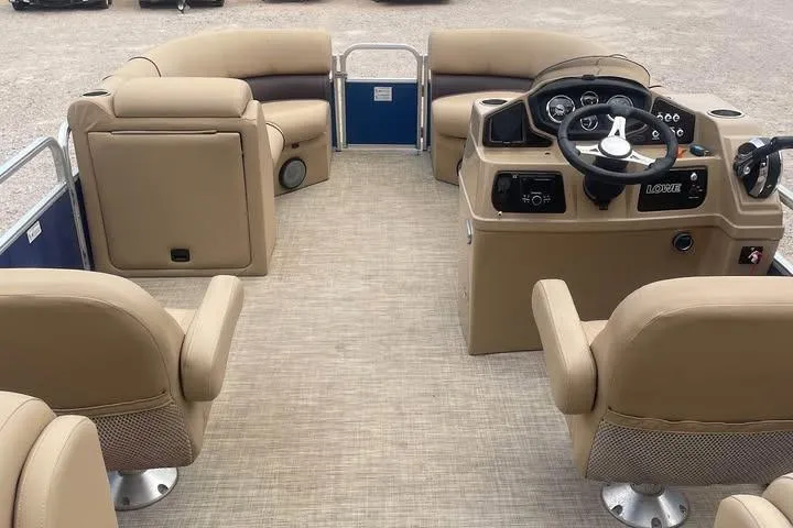 Slide: The Image of 2018 Lowe SS230 Walk-Thru pontoon boat interior with beige seating and steering console. - 8