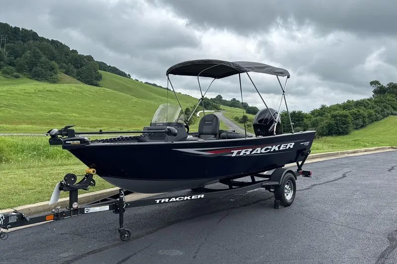 Slide: The Image of 2026 Tracker Pro Guide V-16 SC boat on trailer, parked on paved road. - 2