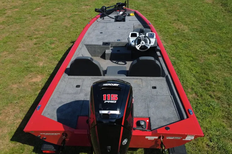 Slide: The Image of 2026 Tracker Pro Team 190 boat with Mercury 115 engine on grassy field. - 3