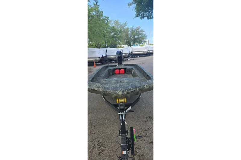 Slide: The Image of 2026 Tracker Grizzly 1650 T Prairie Wings Edition boat with Mercury 60 engine on urban street. - 3