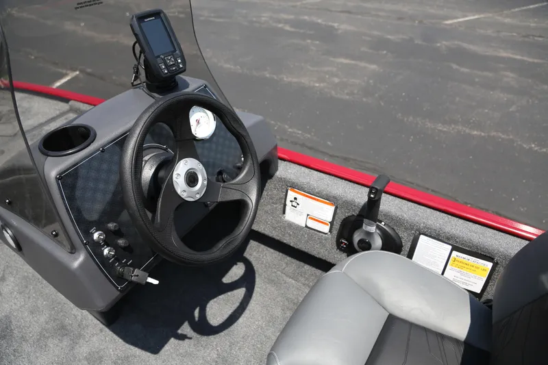 Slide: The Image of 2026 Tracker Bass Tracker Classic XL boat cockpit with steering wheel and control panel. - 3