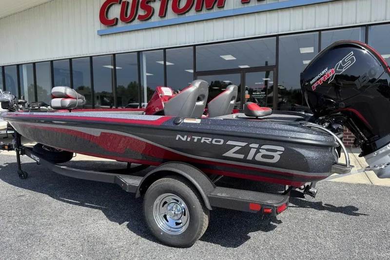 Slide: The Image of 2026 Nitro Z18 Pro boat with Mercury Pro XS engine, parked outside a custom shop. - 7