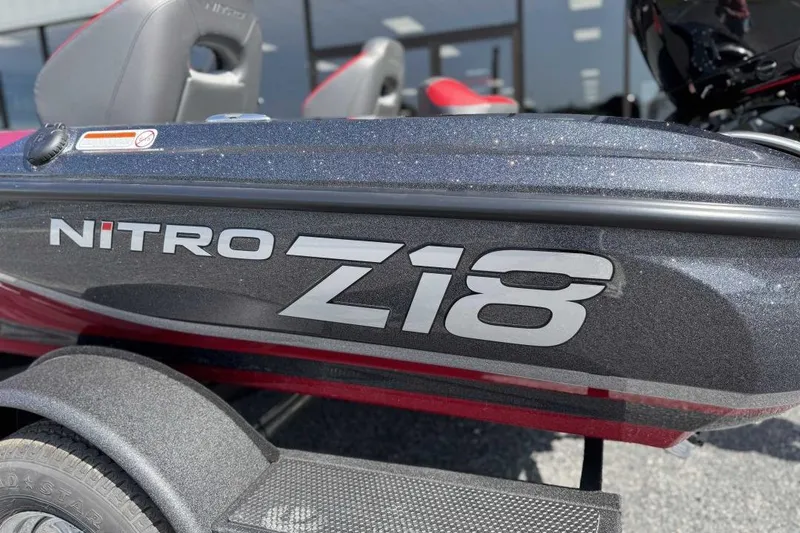 Slide: The Image of 2026 Nitro Z18 Pro boat, close-up of logo and seating, outdoors. - 9