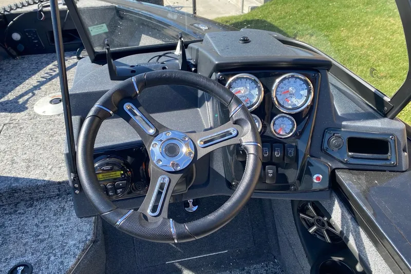Slide: The Image of 2026 Tracker Targa V-18 Combo boat dashboard with steering wheel and gauges. - 6