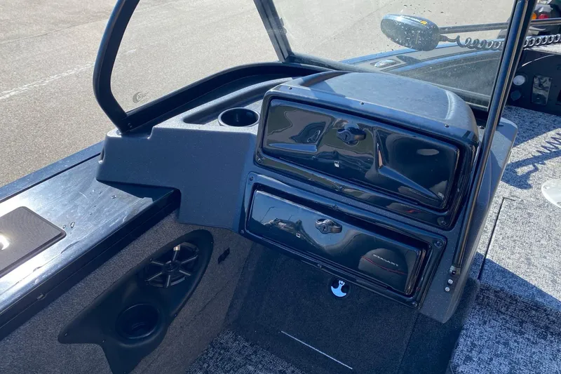 Slide: The Image of 2026 Tracker Targa V-18 Combo boat dashboard with storage compartments and speaker. - 7