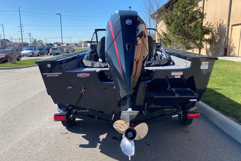 Slide: The Image of 2026 Tracker Targa V-18 Combo boat with powerful outboard motor, parked outdoors. - 9