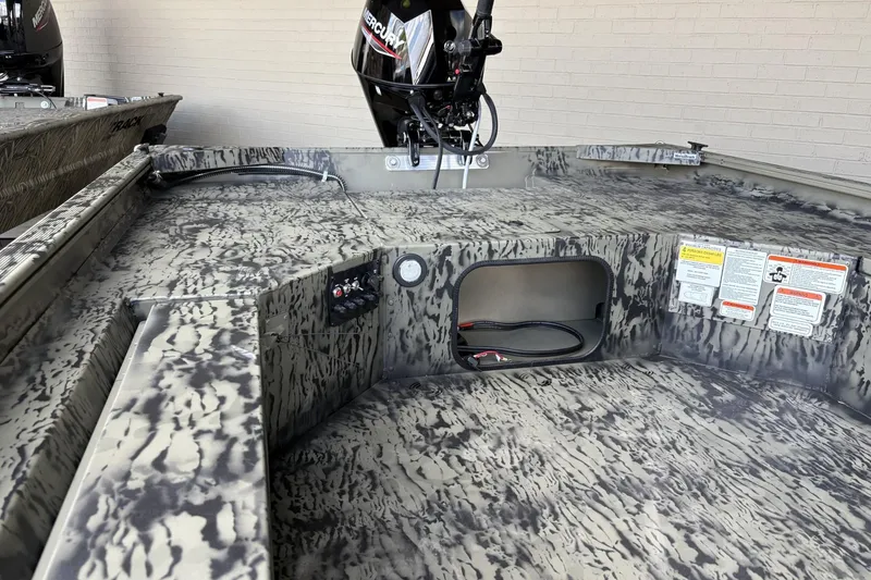 Slide: The Image of 2026 Tracker Grizzly 1654 T Sportsman boat interior with camouflage design and Mercury engine. - 2