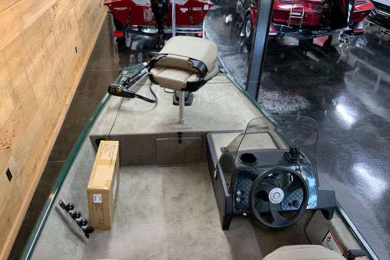 Slide: The Image of 2026 Tracker Bass Tracker Classic Limited boat interior with steering console and seating. - 3