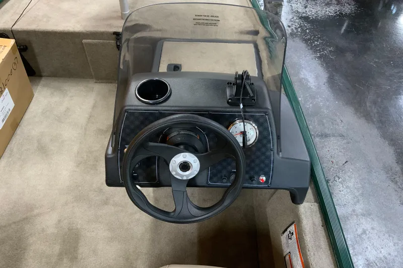 Slide: The Image of 2026 Tracker Bass Tracker Classic Limited boat dashboard with steering wheel and gauges. - 4