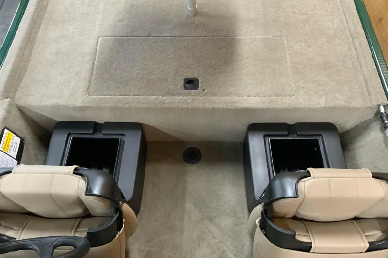 Slide: The Image of Interior of 2026 Tracker Bass Tracker Classic Limited boat with beige seats and storage compartments. - 9