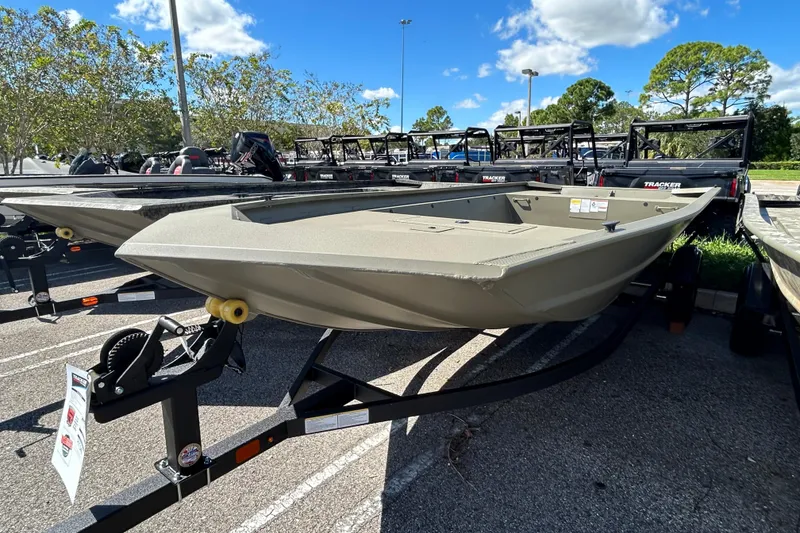 The Image of 2026 Tracker Grizzly 1860 Utility boat on trailer in parking lot. - 0