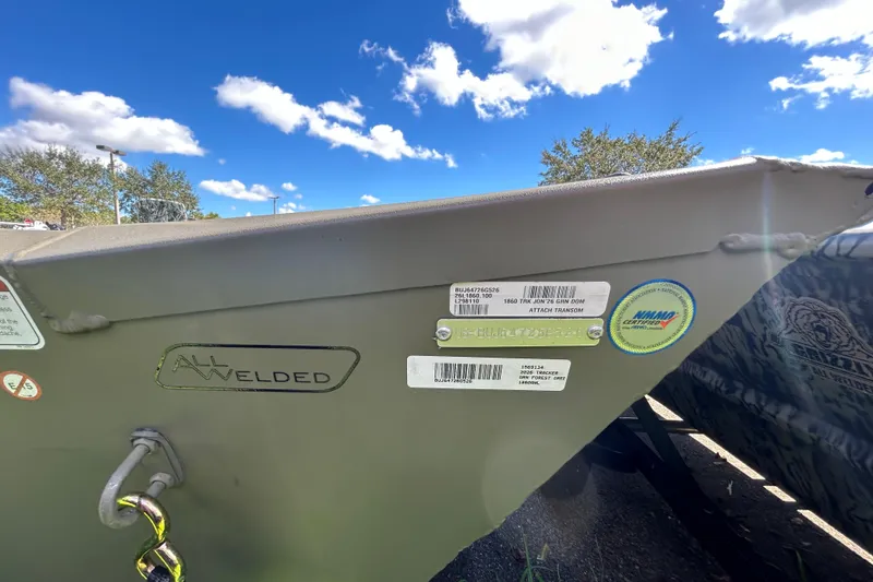 Slide: The Image of 2026 Tracker Grizzly 1860 Utility boat with all-welded hull, under clear blue sky. - 4