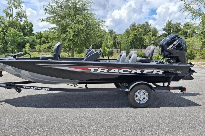 The Image of 2026 Tracker Pro Team 175 boat on trailer, parked outdoors. - 0