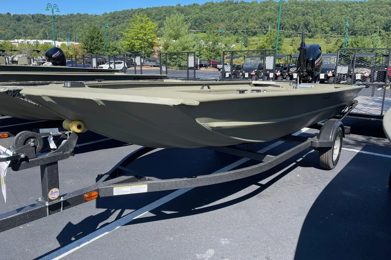The Image of 2026 Tracker Grizzly 1654 T Sportsman boat on trailer in outdoor setting. - 0