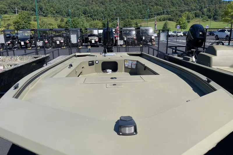 Slide: The Image of 2026 Tracker Grizzly 1654 T Sportsman boat displayed outdoors with scenic background. - 2