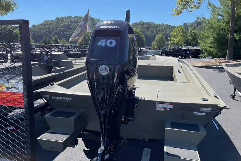 Slide: The Image of 2026 Tracker Grizzly 1654 T Sportsman boat with Mercury 40 engine in outdoor setting. - 3