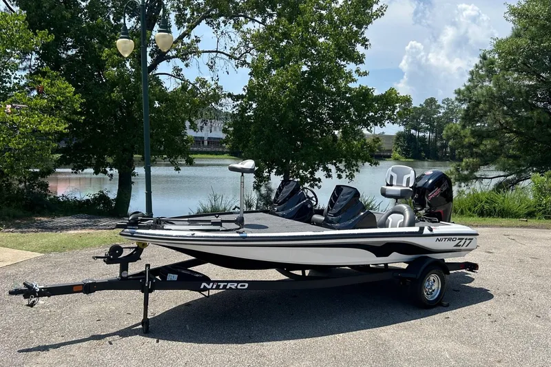 The Image of 2026 Nitro Z17 boat on trailer by a lake, surrounded by trees. - 0