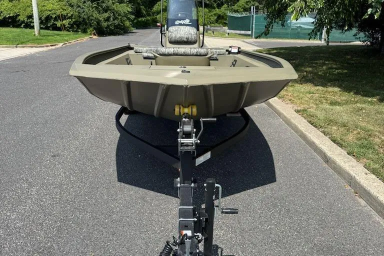 Slide: The Image of 2026 Tracker Grizzly 1860 CC boat on trailer, parked on a suburban street. - 4