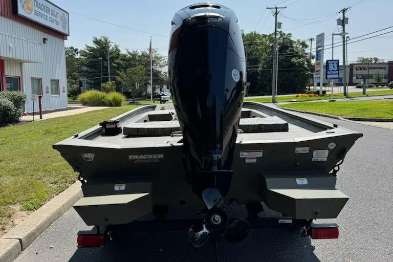 Slide: The Image of 2026 Tracker Grizzly 1860 CC boat with outboard motor in parking lot. - 5