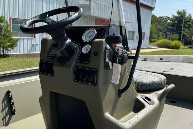 Slide: The Image of Steering console of 2026 Tracker Grizzly 1860 CC boat with gauges and controls. - 6
