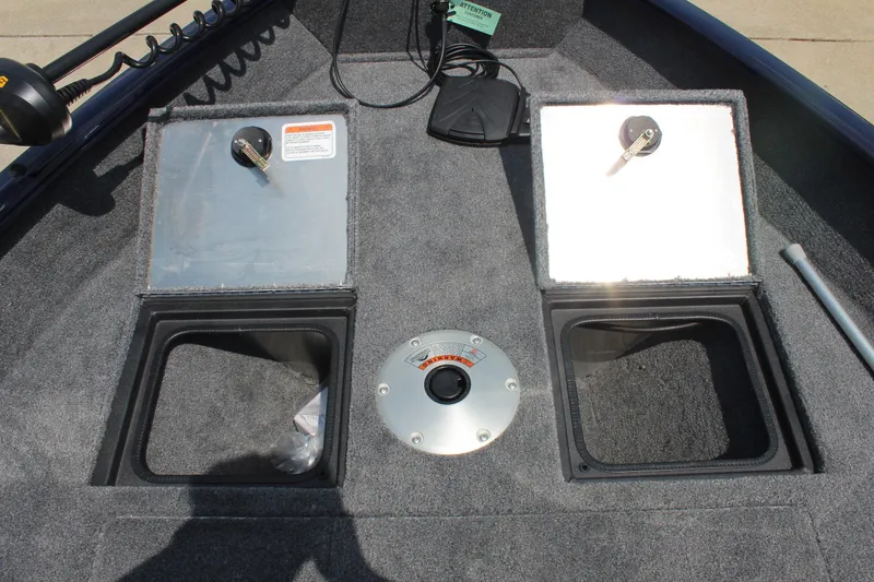 Slide: The Image of 2026 Tracker Pro Guide V-16 WT boat storage compartments and control panel. - 14