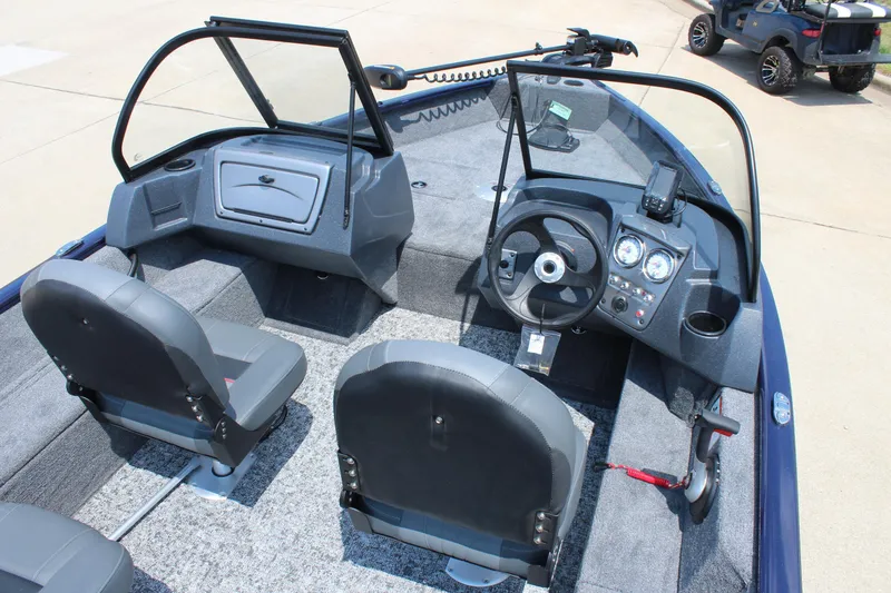 Slide: The Image of 2026 Tracker Pro Guide V-16 WT boat interior with steering console and seating. - 9