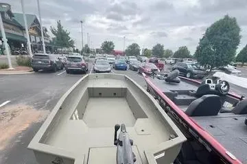 Slide: The Image of 2026 Tracker Grizzly 1650 T Prairie Wings Edition boat in parking lot. - 2