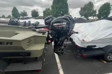 Slide: The Image of 2026 Tracker Grizzly 1650 T Prairie Wings Edition boat with Mercury outboard motor in parking lot. - 3