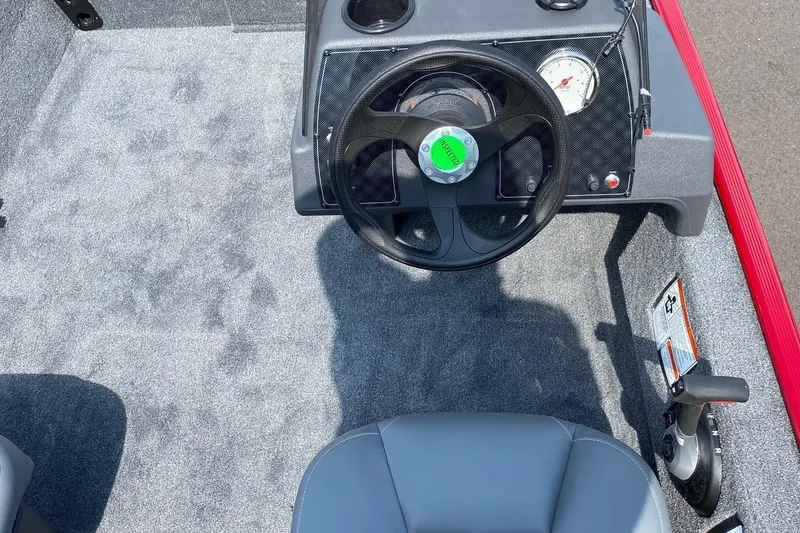 Slide: The Image of 2026 Tracker Bass Tracker Classic XL boat interior with steering wheel and controls. - 7