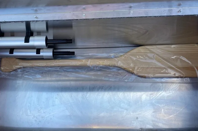 Slide: The Image of 2026 Tracker Bass Tracker Classic XL boat interior with paddle and equipment storage. - 8