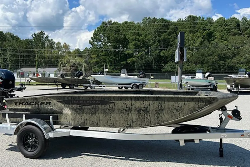 Slide: The Image of 2026 Tracker Grizzly 1650 T Prairie Wings Edition boat on trailer, outdoors. - 3