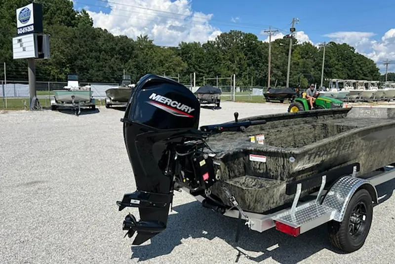 Slide: The Image of 2026 Tracker Grizzly 1650 T Prairie Wings Edition boat with Mercury engine in outdoor setting. - 4