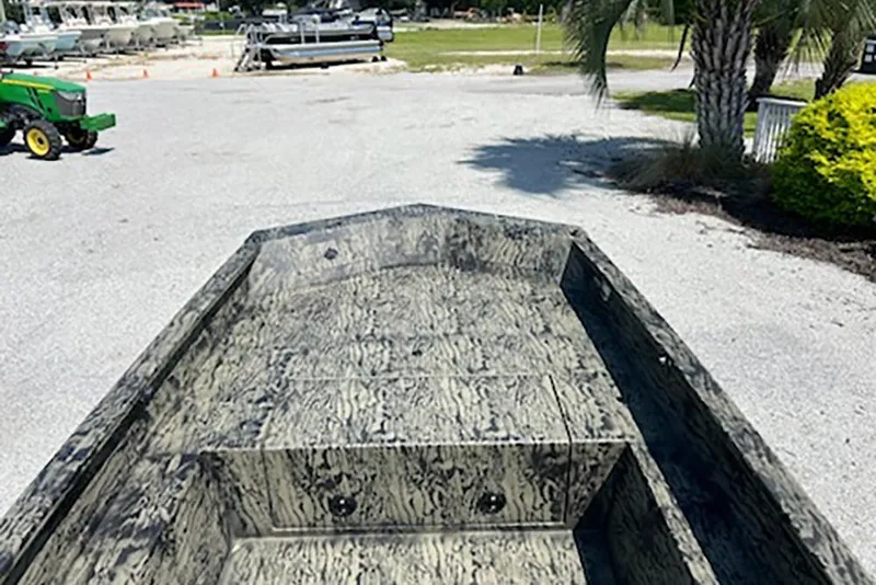 Slide: The Image of 2026 Tracker Grizzly 1650 T Prairie Wings Edition boat with camouflage design in outdoor setting. - 6