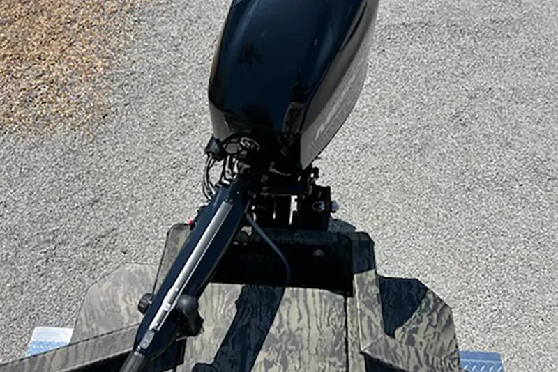 Slide: The Image of 2026 Tracker Grizzly 1650 T Prairie Wings Edition boat with camo design and outboard motor. - 8