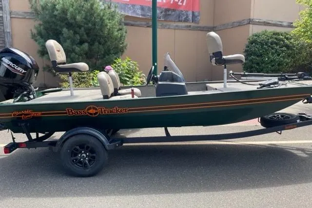 The Image of 2026 Tracker Bass Tracker Classic Limited boat on trailer, parked outdoors. - 0