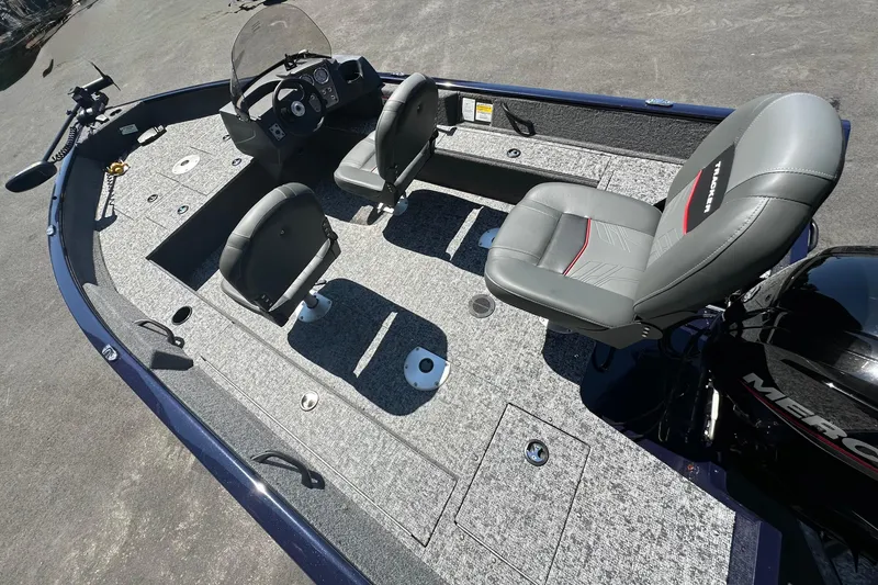 Slide: The Image of 2026 Tracker Pro Guide V-16 SC boat interior with seating and steering console. - 2