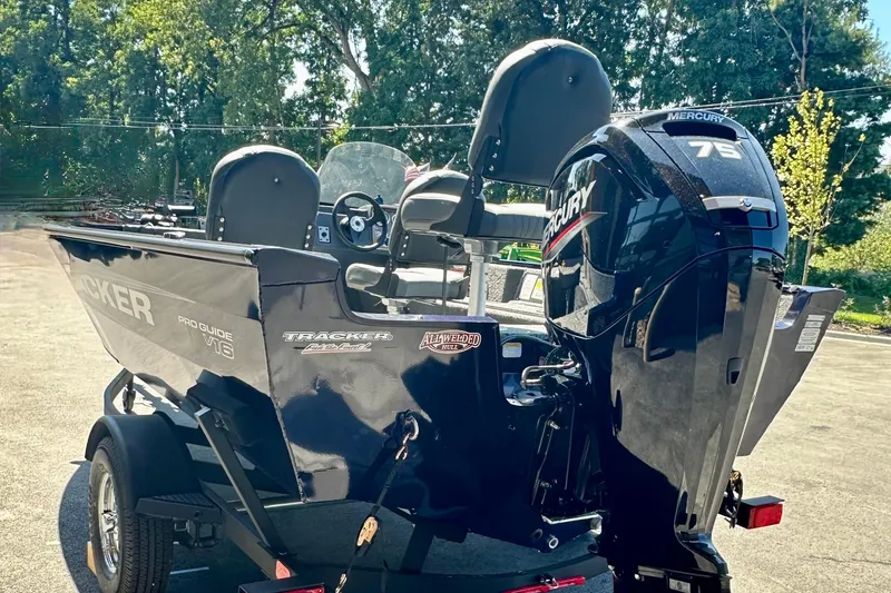 Slide: The Image of 2026 Tracker Pro Guide V-16 SC boat with Mercury 75 engine, parked outdoors. - 3