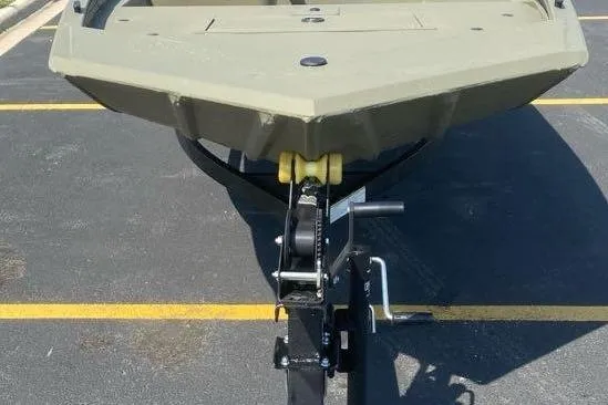 Slide: The Image of 2026 Tracker Grizzly 1648 SC boat on trailer, parked in a lot. - 2