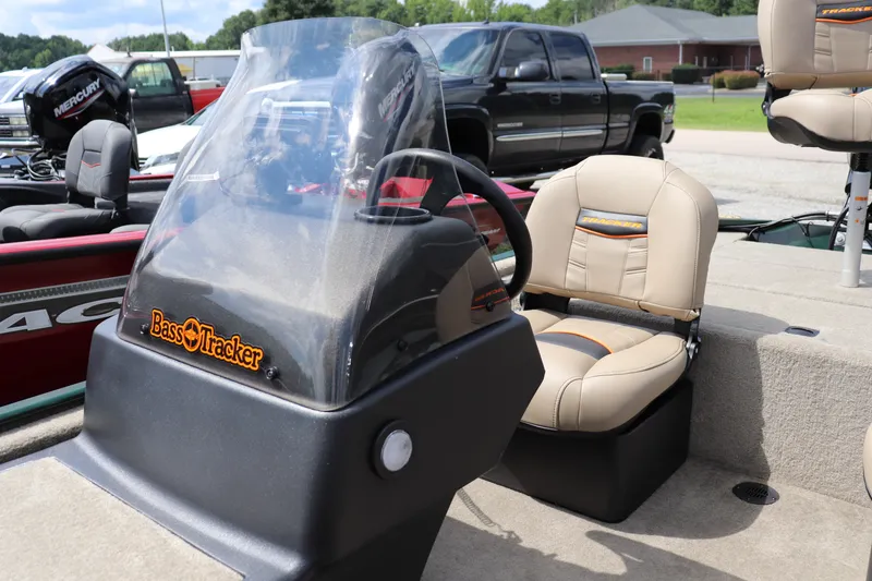 Slide: The Image of 2026 Tracker Bass Tracker Classic Limited boat interior with steering console and seating. - 6
