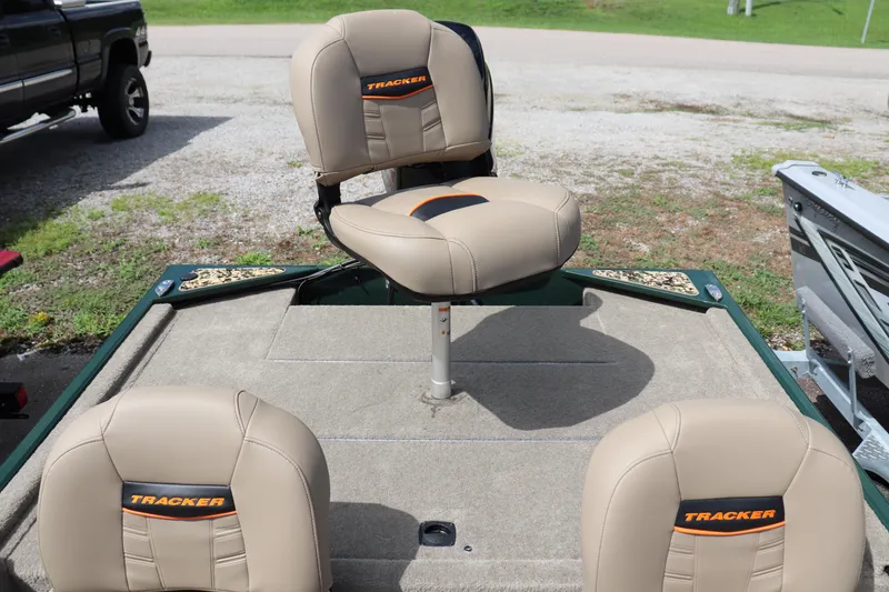 Slide: The Image of 2026 Tracker Bass Tracker Classic Limited boat seats, beige upholstery, outdoor setting. - 9