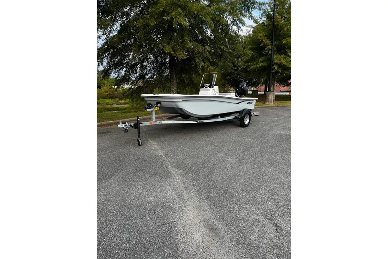 The Image of 2026 Mako Pro Skiff 15 CC boat on trailer, parked outdoors. - 1