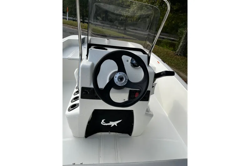 Slide: The Image of 2026 Mako Pro Skiff 15 CC boat console with steering wheel and controls. - 6