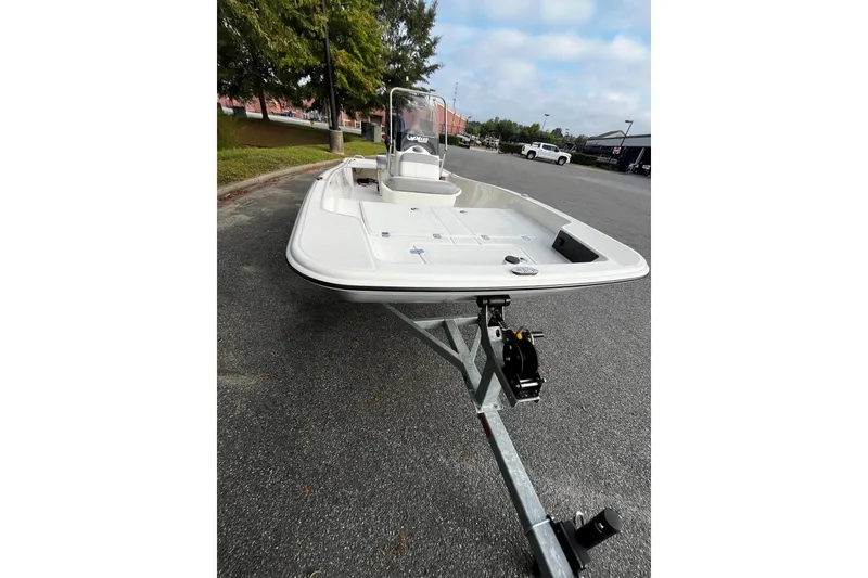 Slide: The Image of 2026 Mako Pro Skiff 15 CC on trailer, parked outdoors, showcasing sleek design. - 7
