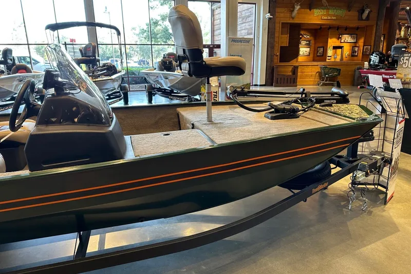 Slide: The Image of 2026 Tracker Bass Tracker Classic Limited boat displayed indoors on a trailer. - 2