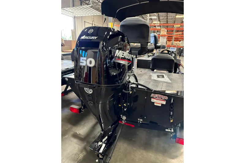 Slide: The Image of 2026 Tracker Bass Tracker Classic Limited with Mercury 50 outboard motor in a warehouse. - 4