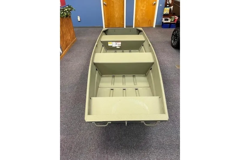 Slide: The Image of 2026 Tracker Grizzly 12 Jon boat, olive green, displayed indoors on carpet. - 5