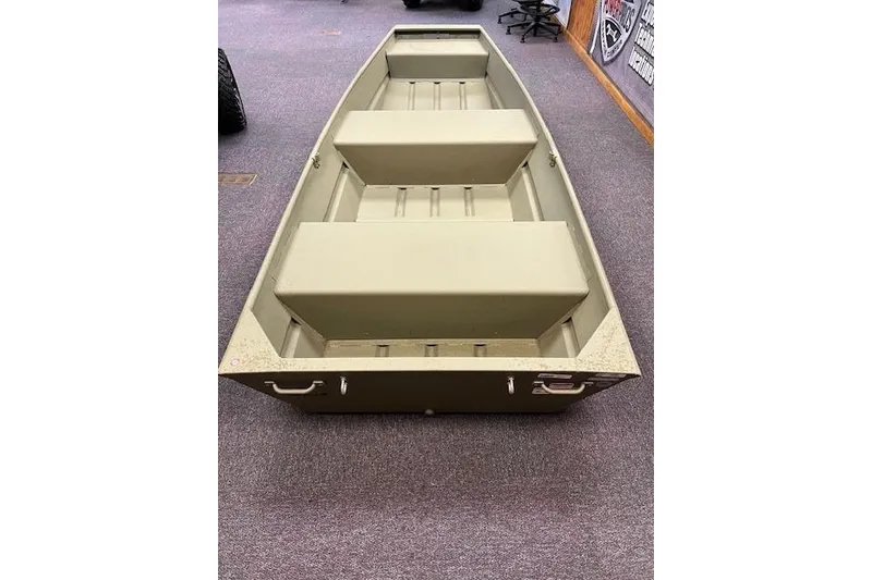 Slide: The Image of 2026 Tracker Grizzly 12 Jon boat displayed indoors on carpeted floor. - 6