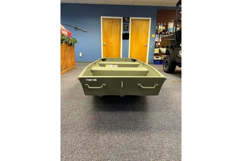 Slide: The Image of 2026 Tracker Grizzly 12 Jon boat displayed indoors on carpeted floor. - 8